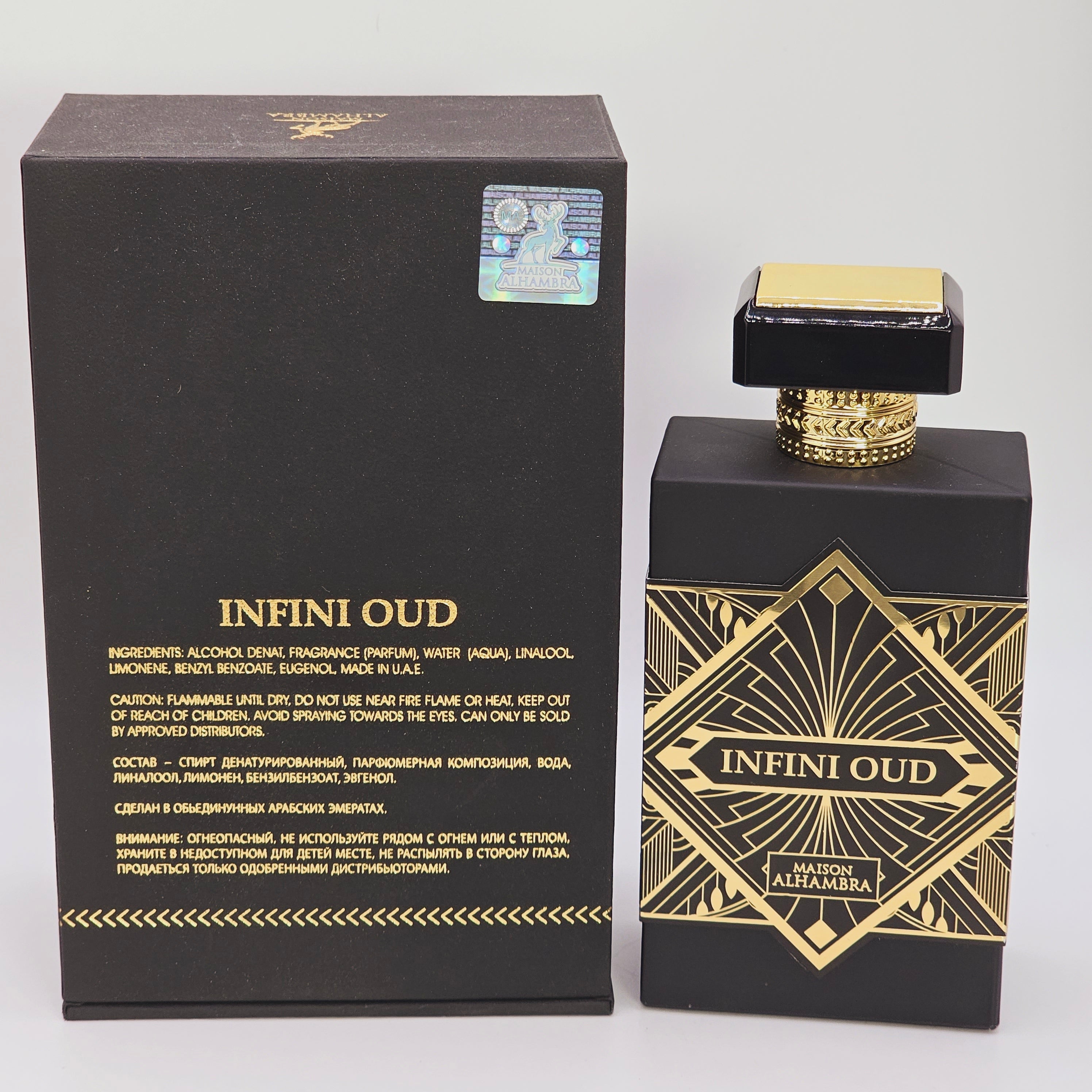 The image shows a black and gold bottle of 'Infini Oud' eau de parfum by Maison Alhambra. The packaging is elegant with intricate gold patterns and the brand's logo.
