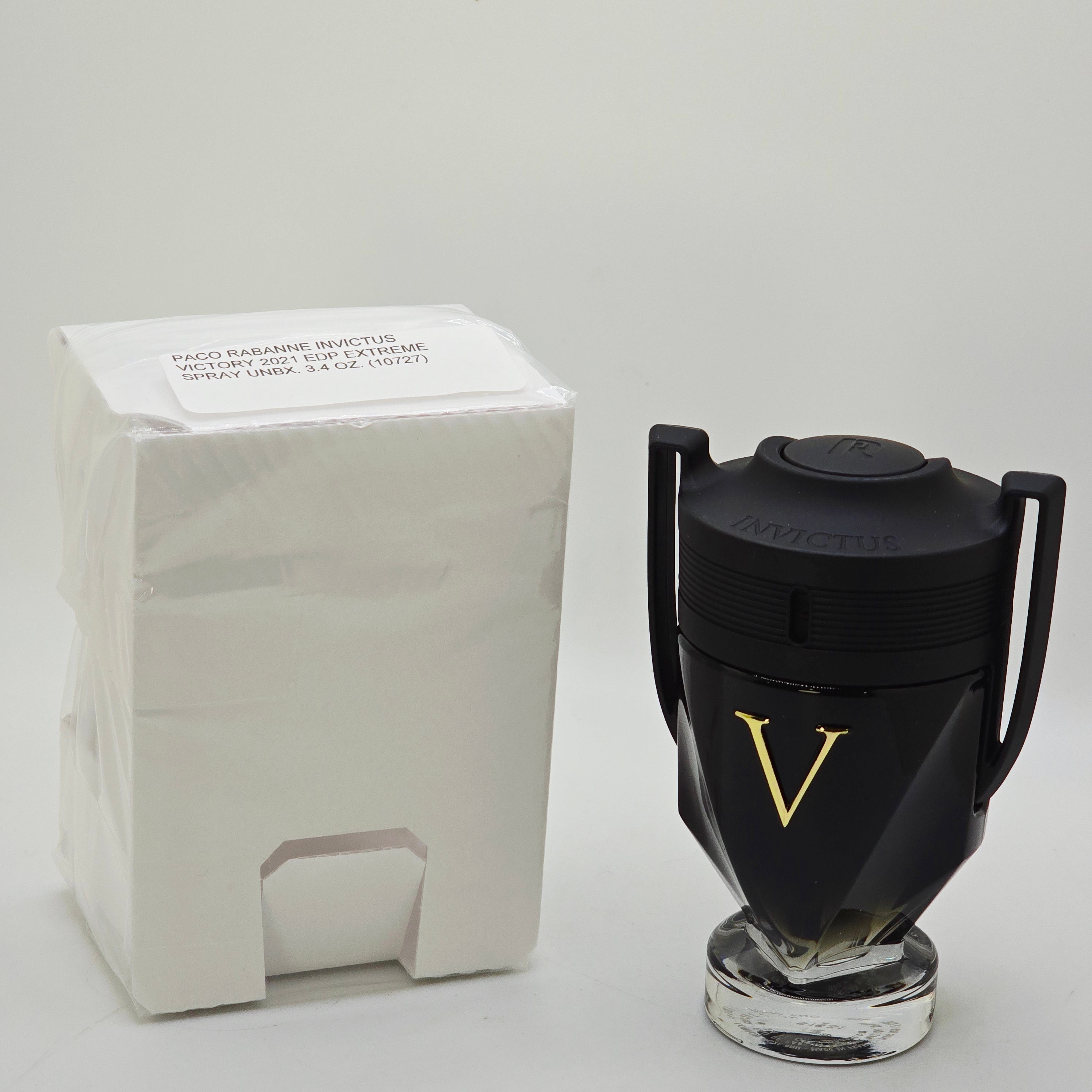 Black coffee grinder with a gold accent on a white background