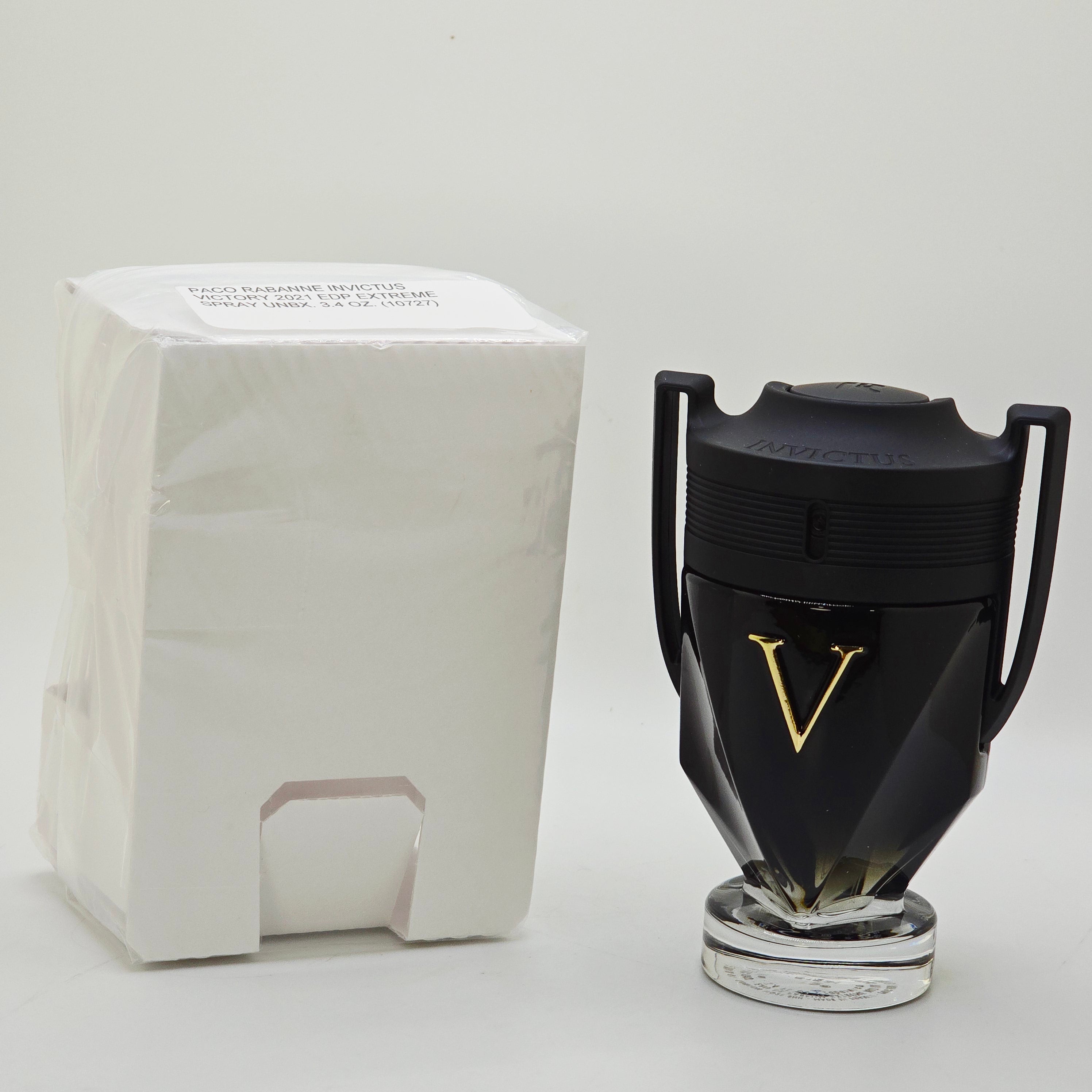 Black coffee grinder with a gold accent on a white background