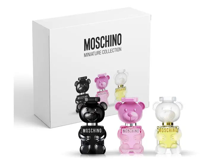 Moschino miniature perfume collection with colorful bear-shaped bottles and a branded box on a white background.