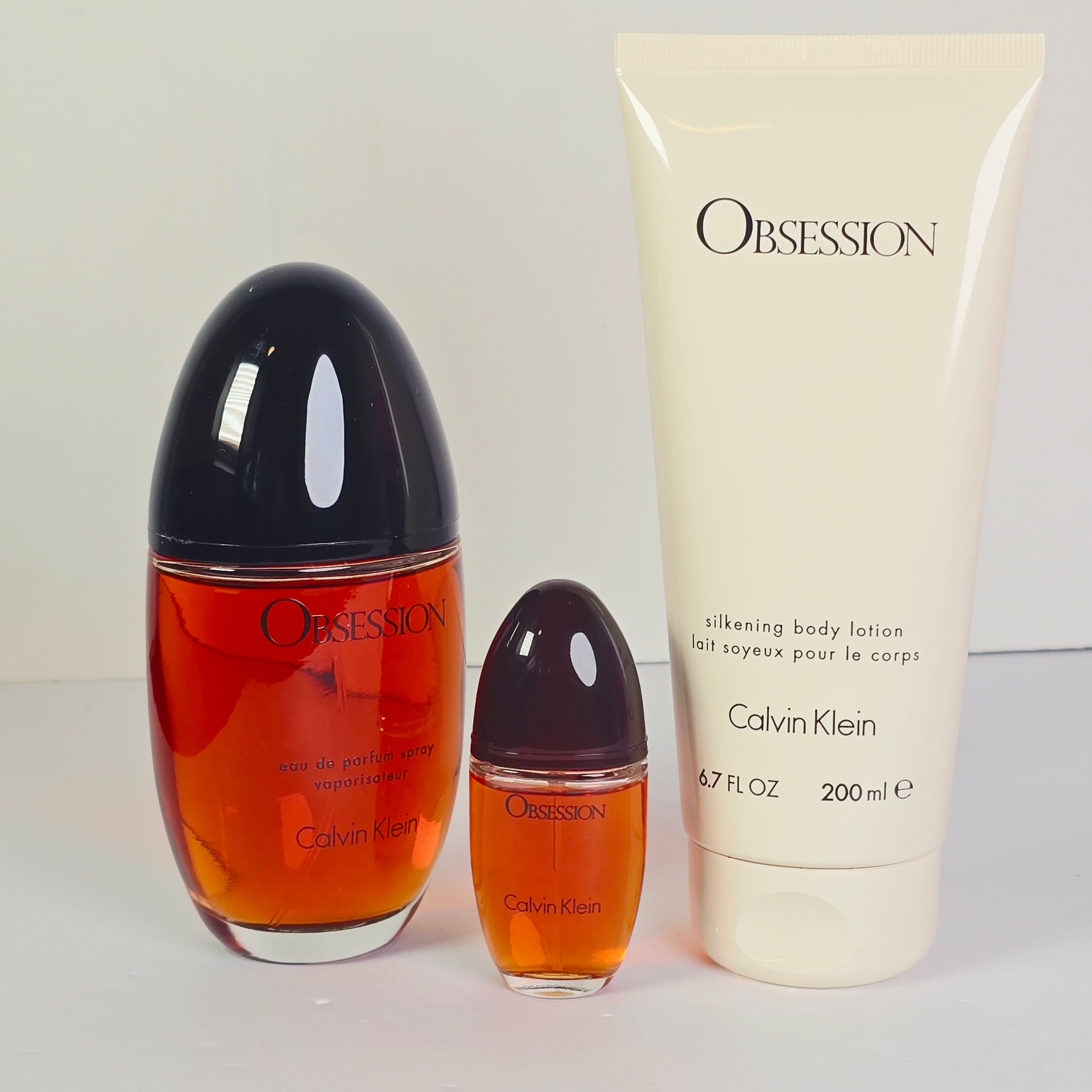 Calvin Klein Obsession perfume set on a red background