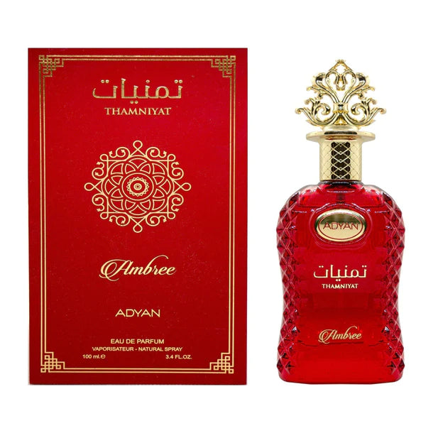 A red bottle of Thamniyat Ambree by Adyan with a gold cap, next to its packaging box.