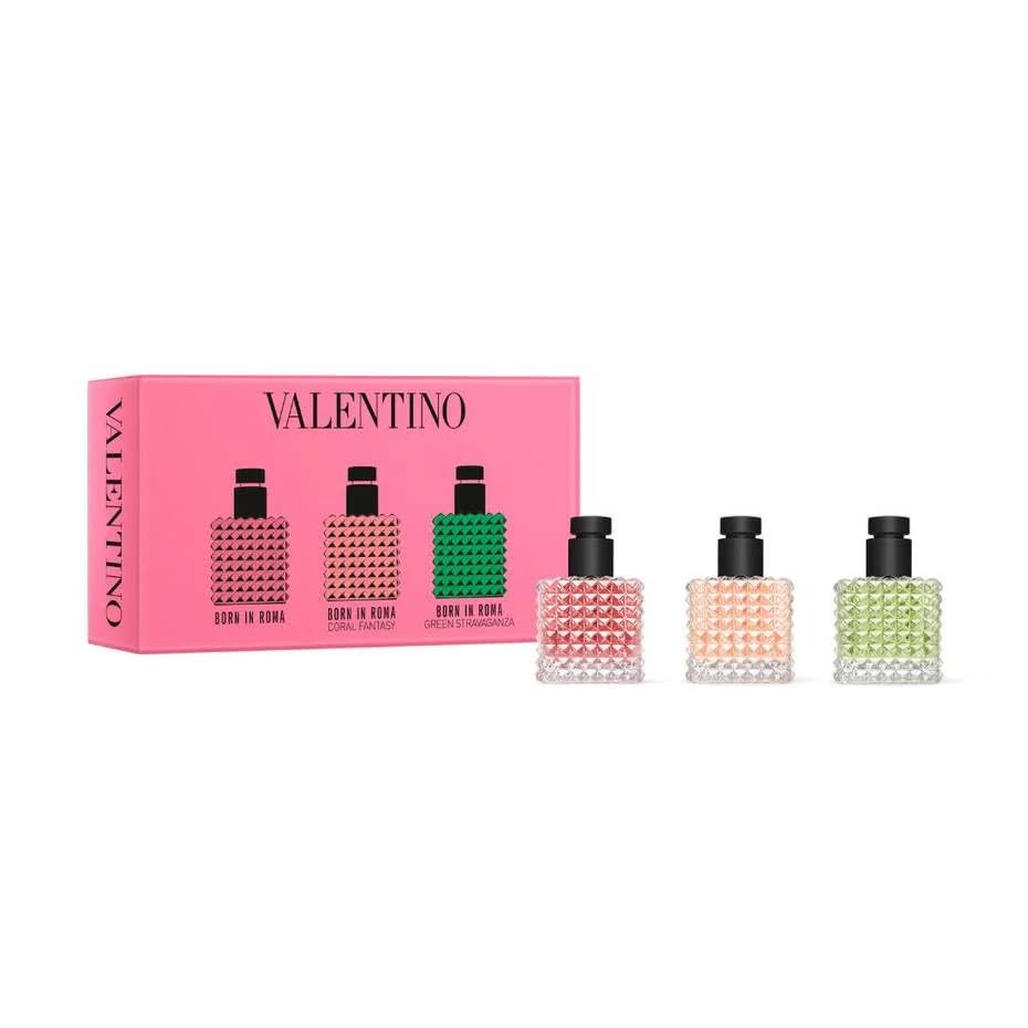 Valentino perfume set with four bottles in front of a pink box on a white background